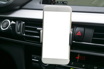 Smartphone in a car use for Navigate or GPS. Driving a car with Smartphone in holder. Mobile phone with isolatede white screen. Blank empty screen. copy space. Empty space for text. car interior 
