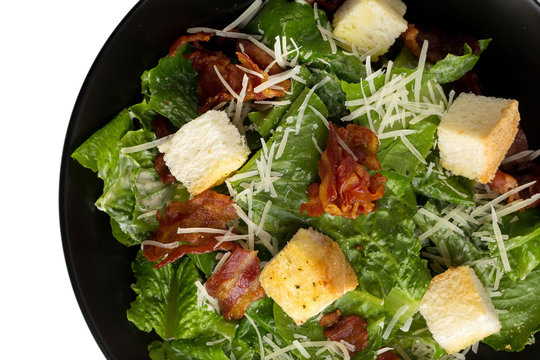 Caesar salad with crispy bacon fry and Fresh green cos lettuce isolated on white background
