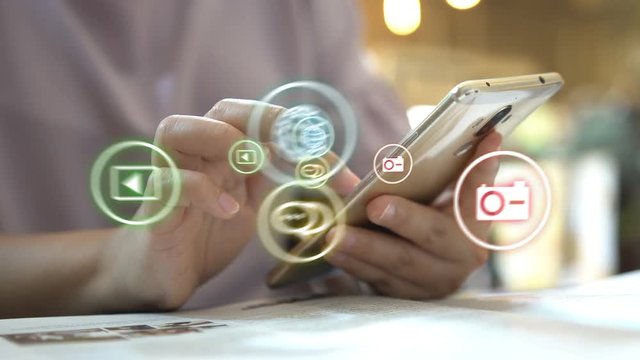 Hand touch screen smart phone, social icons interface on screen, connect to the future concept. 