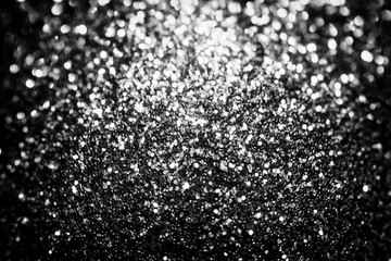 Black glitter sparkle background. Black friday shiny pattern with sequins. Christmas glamour luxury pattern, black christmas and glitter diamond background. Dark silver pattern.