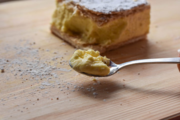 Sweet cream pie slice on a wooden background