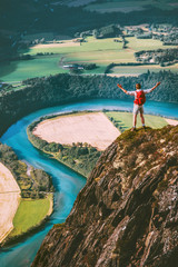Happy Man traveler standing on cliff mountain hands raised Travel Lifestyle success motivation concept adventure active vacations outdoor river aerial view