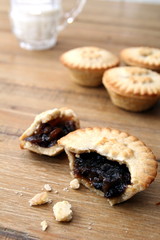 Selection of several mince pies, some broken open or partly eaten. A traditional festive Christmas dessert or pudding.