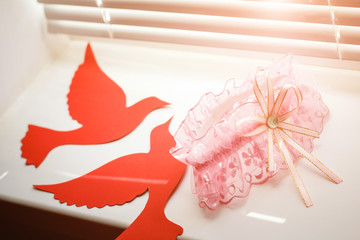 Red paper pigeons on a white background, wedding, garter