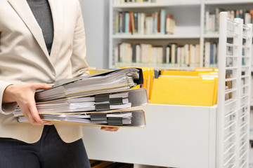 Woman searching for documents in archive