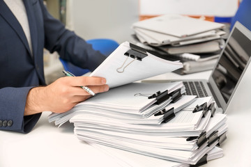 Man working with documents at table in archive