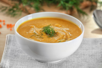 Bowl of homemade lentils creme soup on table, closeup
