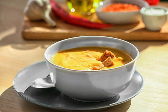 Bowl of homemade lentils creme soup on table, closeup