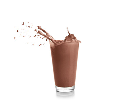 Glass with splashing cocoa, isolated on white