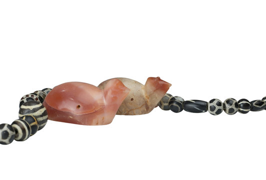 Ancient Pyu carnelian turtle and round shaped etched agate beads in necklace isolated on white background
