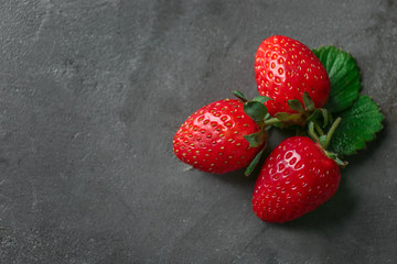 Fresh ripe strawberries on grey background