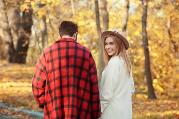 Fototapeta premium Young couple walking in park on autumn day