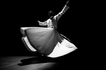 the image of a whirling Dervish in the darkness
