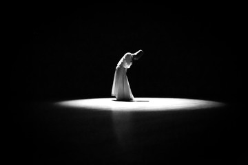 Naklejka premium the image of a whirling Dervish in the darkness