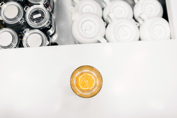 The cut lemon lies on the bottom of the glass, the bar counter, the top view