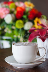 Obraz na płótnie Canvas Hot coffee in a white cup in a coffee shop