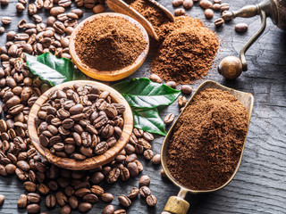 Roasted coffee beans  and ground coffee on wooden table. Top view.