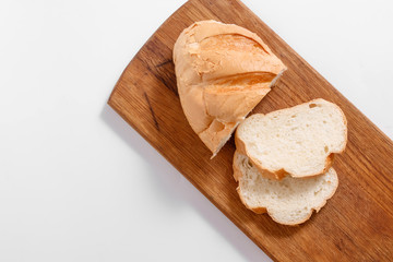 Top view of slices of white bread on a kitchen board, on a white background.