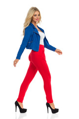 Sexy Blond Woman Is Walking In Jacket, Red Pants And High Heels