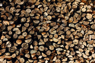 ends of logs wooden background. toning. wood in the stack.