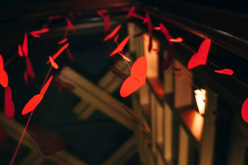 Garland of red hearts on a dark background. The concept of Valentine's Day