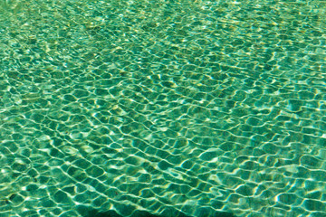 Green swimming pool rippled water detail