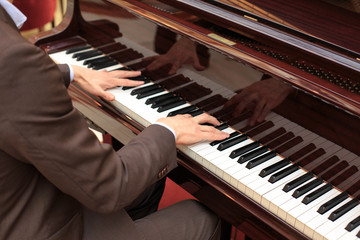 Handsome young men playing piano