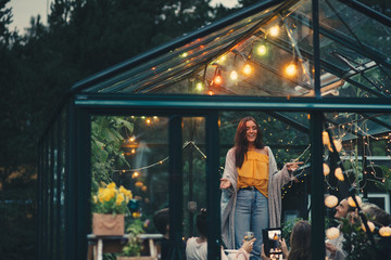 People partying in garden greenhouse