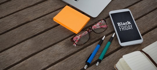 Composite image of mobile phone, laptop, pen, sticky note,