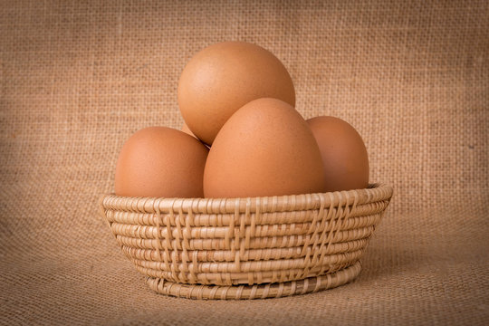 Eggs in a basket on  gunny (sackcloth)  background