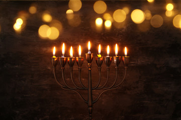 Low key image of jewish holiday Hanukkah background with menorah (traditional candelabra) and...