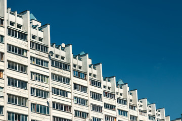 Fototapeta premium Multi-storey building in the form of steps against the blue sky