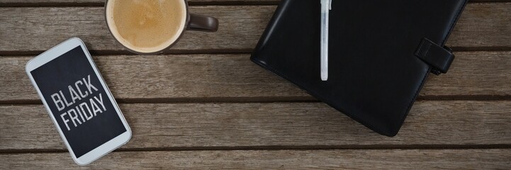 Composite image of mobile phone, coffee, pen and organizer on