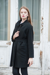 Beautiful young woman posing in the autumn wear