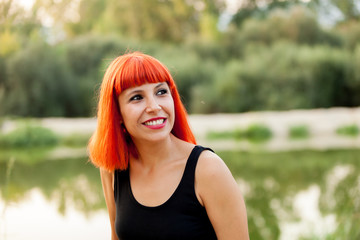 Portrait of red haired woman enjoying of the nature