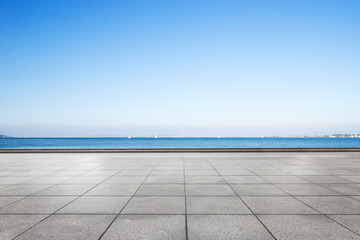 empty marble floor and blue sea in blue cloud sky