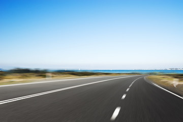 Fototapeta premium empty asphalt road with blue sea in blue sky