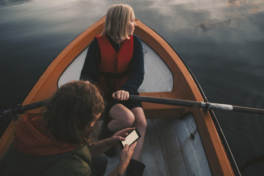 Two women  paddling boat