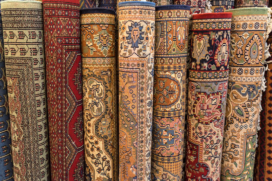 Colorful rolled carpets in oriental marketplace