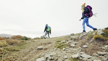 A group of people with backpacks walking along the road.