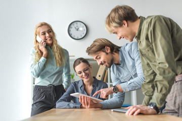 Businessman showing something on tablet