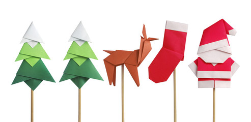 Handmade origami paper craft Santa Claus, green Christmas trees, reindeer and stocking isolated on white - obrazy, fototapety, plakaty