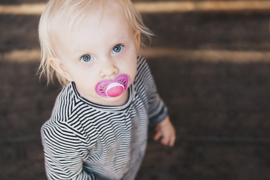 Portrait of girl with pacifier
