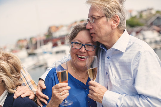 Loving senior couple holding champagne flutes during summer vacation