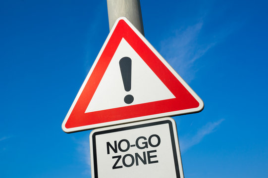 No go zone ( No-go zone / area )  - traffic sign with exclamation mark to alert, warn caution - entering into dangerous and unsafe part of city and town. Ghetto with hign criminality and delinquency