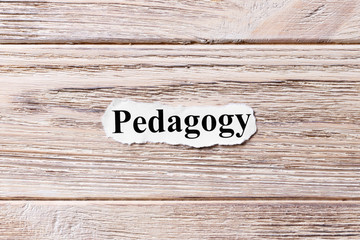 PEDAGOGY of the word on paper. concept. Words of PEDAGOGY on a wooden background