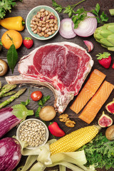 Overhead photo of many fresh food products on rustic tetxure