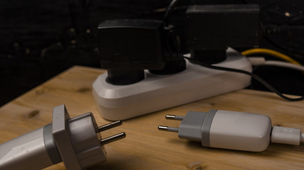 Chargers, electrical cables in the socket concept Electricity