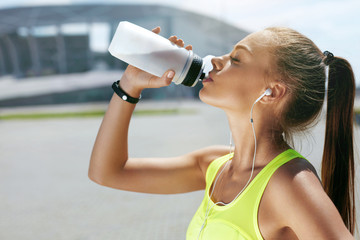 Drink Water From Bottle. Woman Drinking After Running