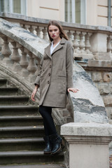 Beautiful young woman posing on the stairs